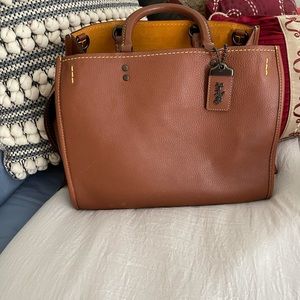 Coach!  Satchel is tan in color.